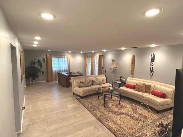 a view of a dining room with furniture and a potted plant