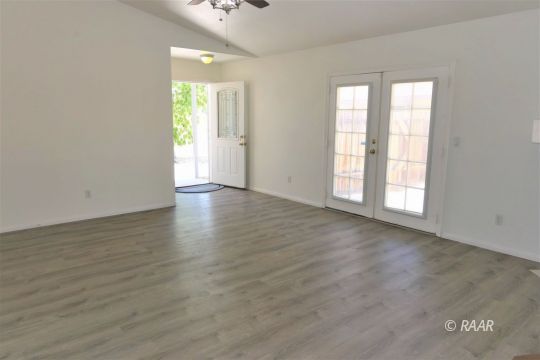 1420 South Yorktown Street Ridgecrest, CA 93555 - Photo 5 of 27 an empty room with wooden floor and windows