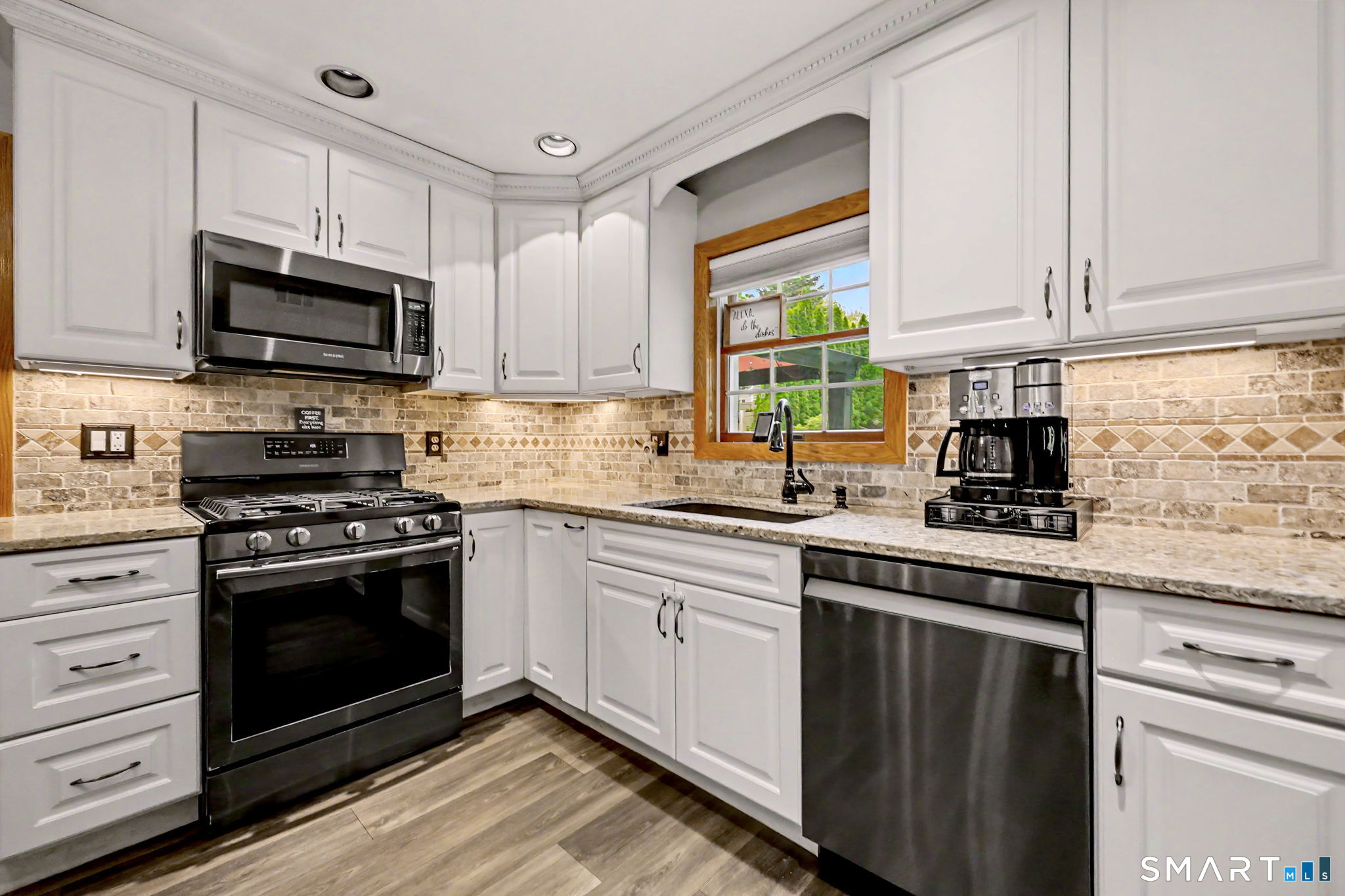 7 Merrill Road Trumbull, CT 06611 - Photo 8 of 40 a kitchen with stainless steel appliances granite countertop a stove a sink and a microwave