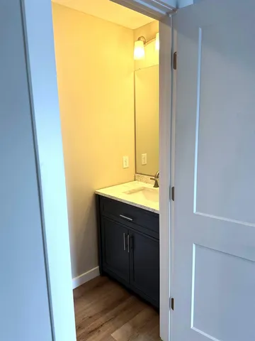 a bathroom with a double vanity sink toilet mirror and shower
