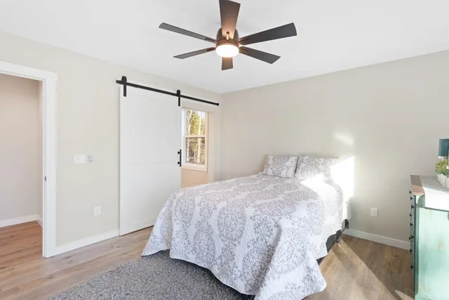 a bathroom with a shower sink mirror and toilet