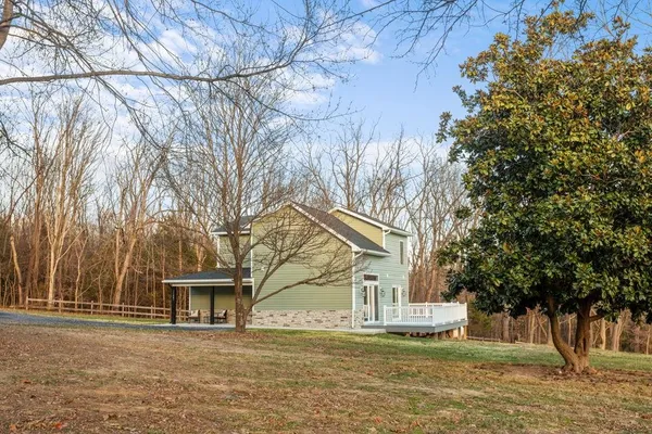 a view of a house with large trees