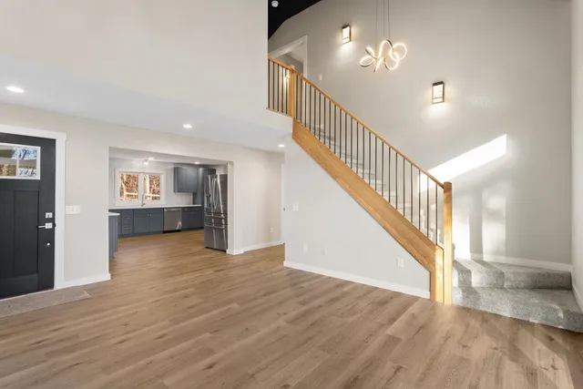a large kitchen with a large counter top space stainless steel appliances and cabinets