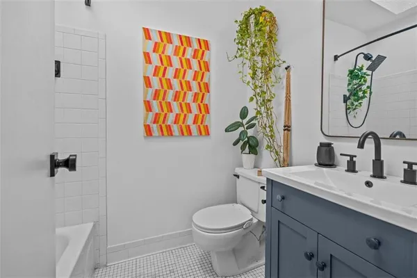a bathroom with a toilet sink and shower curtain
