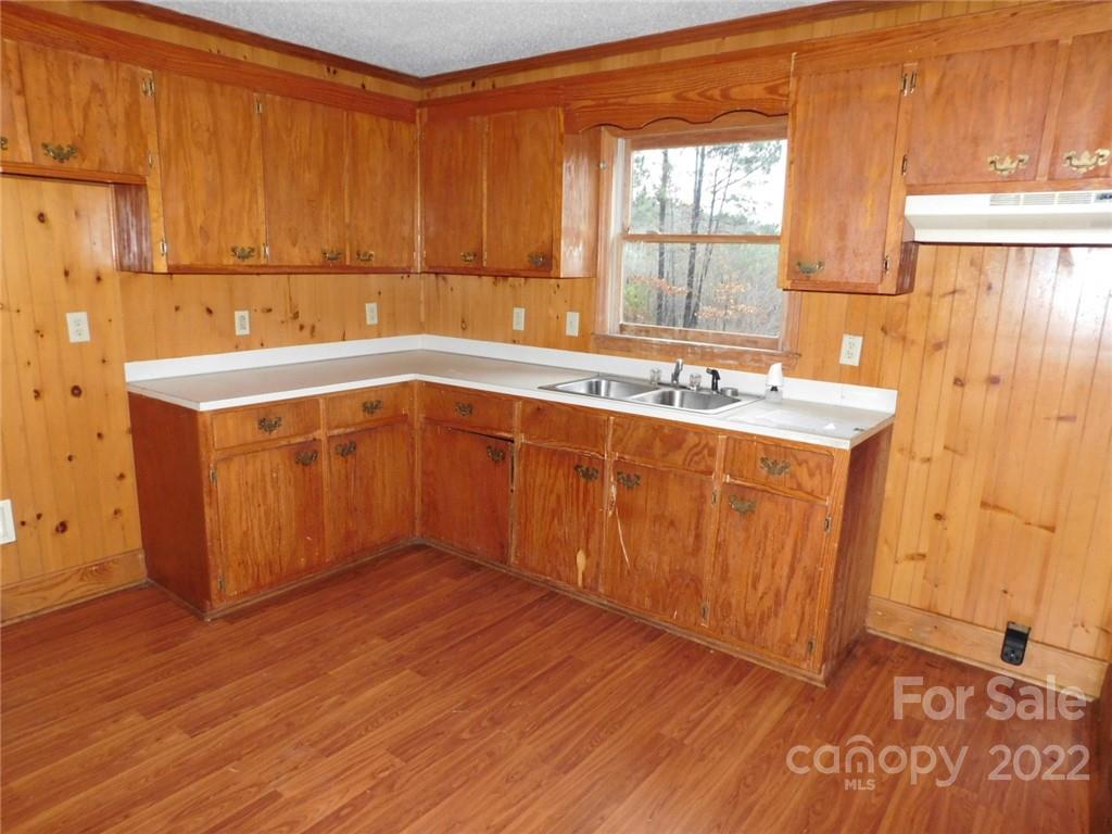 17451 White Store Road Peachland, NC 28133 - Photo 8 of 17 a kitchen with a sink and wooden cabinets
