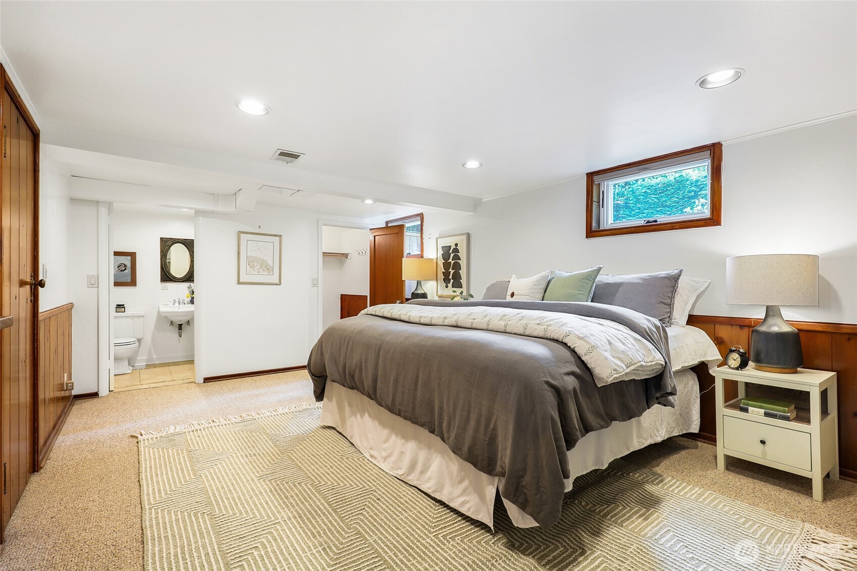 4115 Ashworth Avenue North Seattle, WA 98103 - Photo 15 of 31 a spacious bedroom with a bed and a lamp