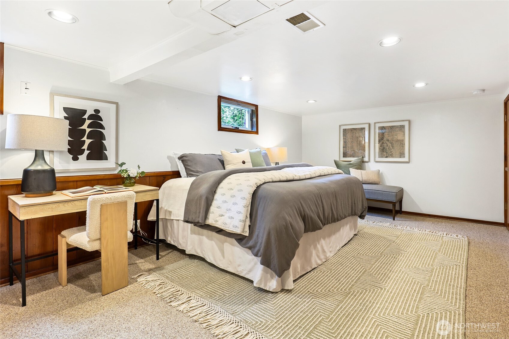 4115 Ashworth Avenue North Seattle, WA 98103 - Photo 16 of 31 a spacious bedroom with a bed a table and painting on the wall