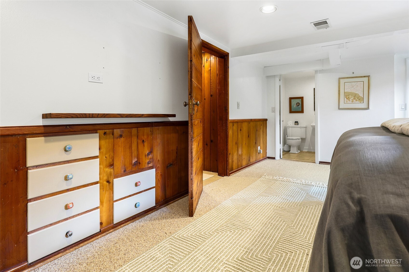 4115 Ashworth Avenue North Seattle, WA 98103 - Photo 17 of 31 a bedroom with a bed and a mirror