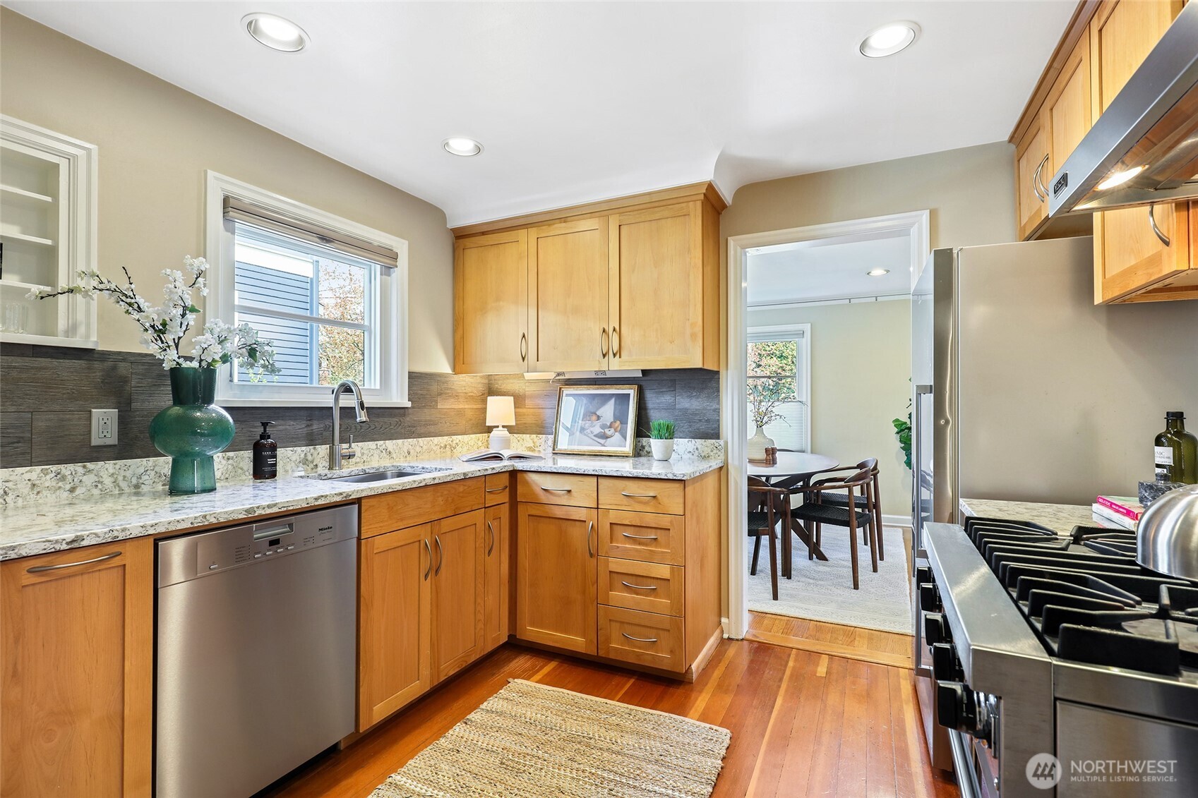 4115 Ashworth Avenue North Seattle, WA 98103 - Photo 10 of 31 a kitchen with a sink stove and cabinets