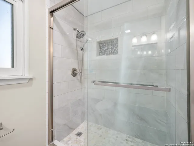 a bathroom with a glass shower door