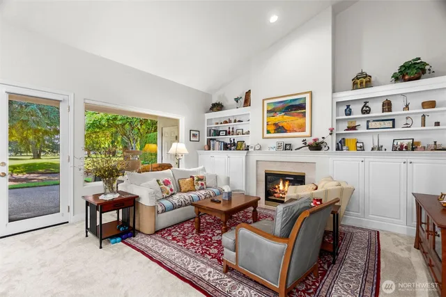 a living room with furniture fireplace and rug