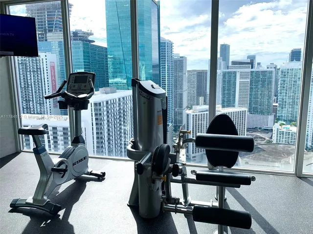 a living room with furniture and floor to ceiling windows