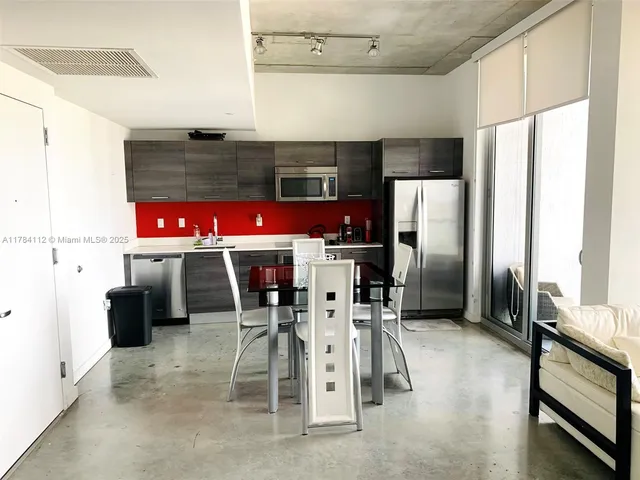 a kitchen with stainless steel appliances a refrigerator and a stove top oven