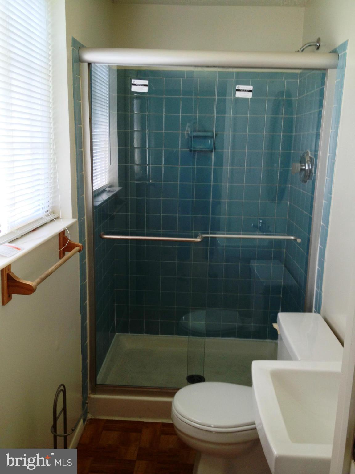 9218 Briarchip Street Laurel, MD 20708 - Photo 11 of 38 a bathroom with a toilet and a shower