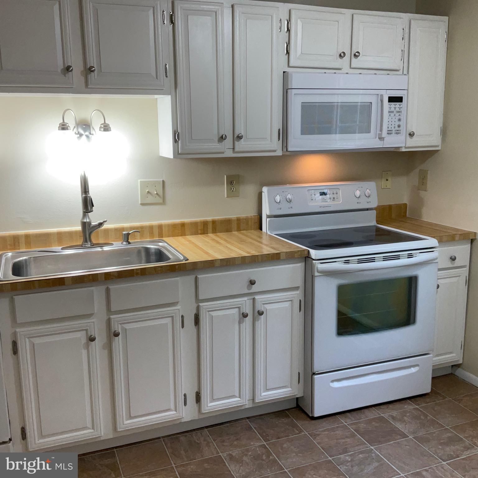 9218 Briarchip Street Laurel, MD 20708 - Photo 17 of 38 a kitchen with cabinets appliances and a sink
