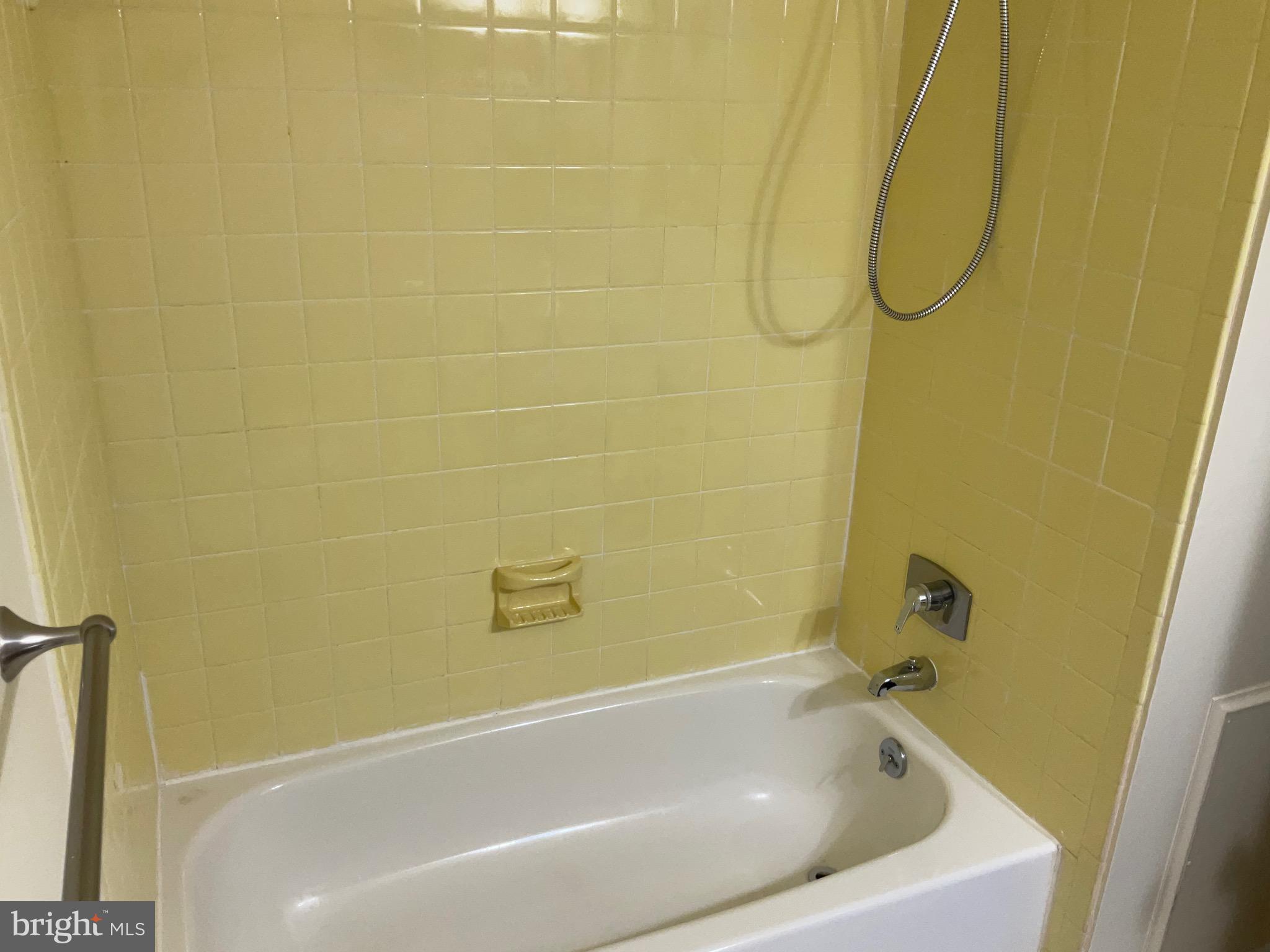 9218 Briarchip Street Laurel, MD 20708 - Photo 21 of 38 a bathroom with a white bath tub and a shower