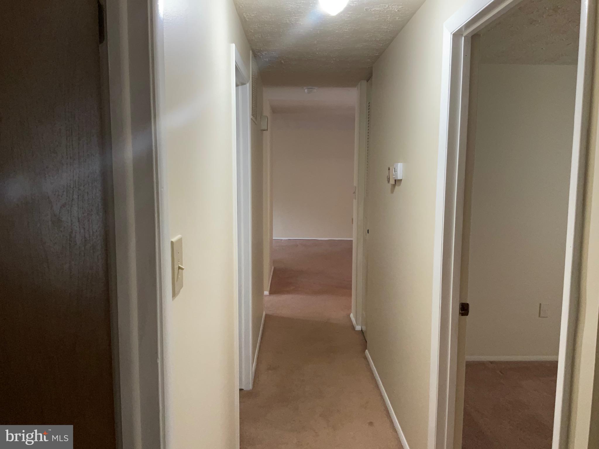 9218 Briarchip Street Laurel, MD 20708 - Photo 25 of 38 a view of a bathroom from a hallway