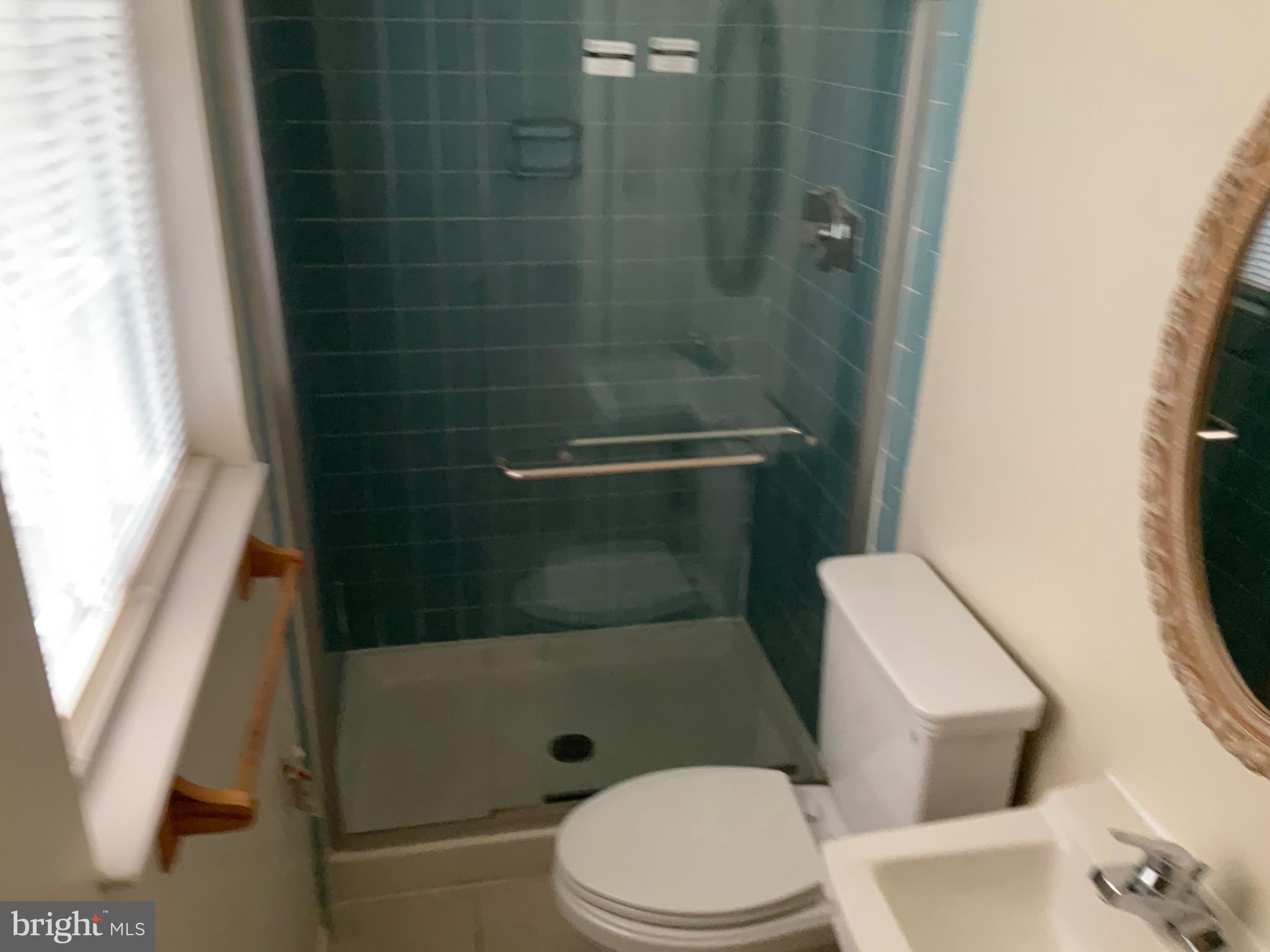 9218 Briarchip Street Laurel, MD 20708 - Photo 28 of 38 a bathroom with a toilet and a shower