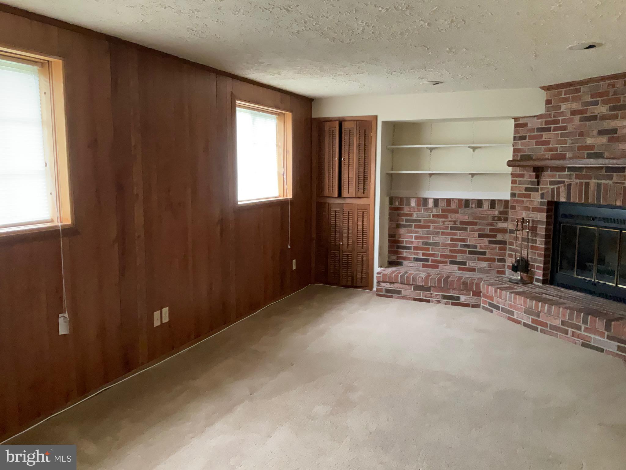9218 Briarchip Street Laurel, MD 20708 - Photo 29 of 38 an empty room with windows and fireplace
