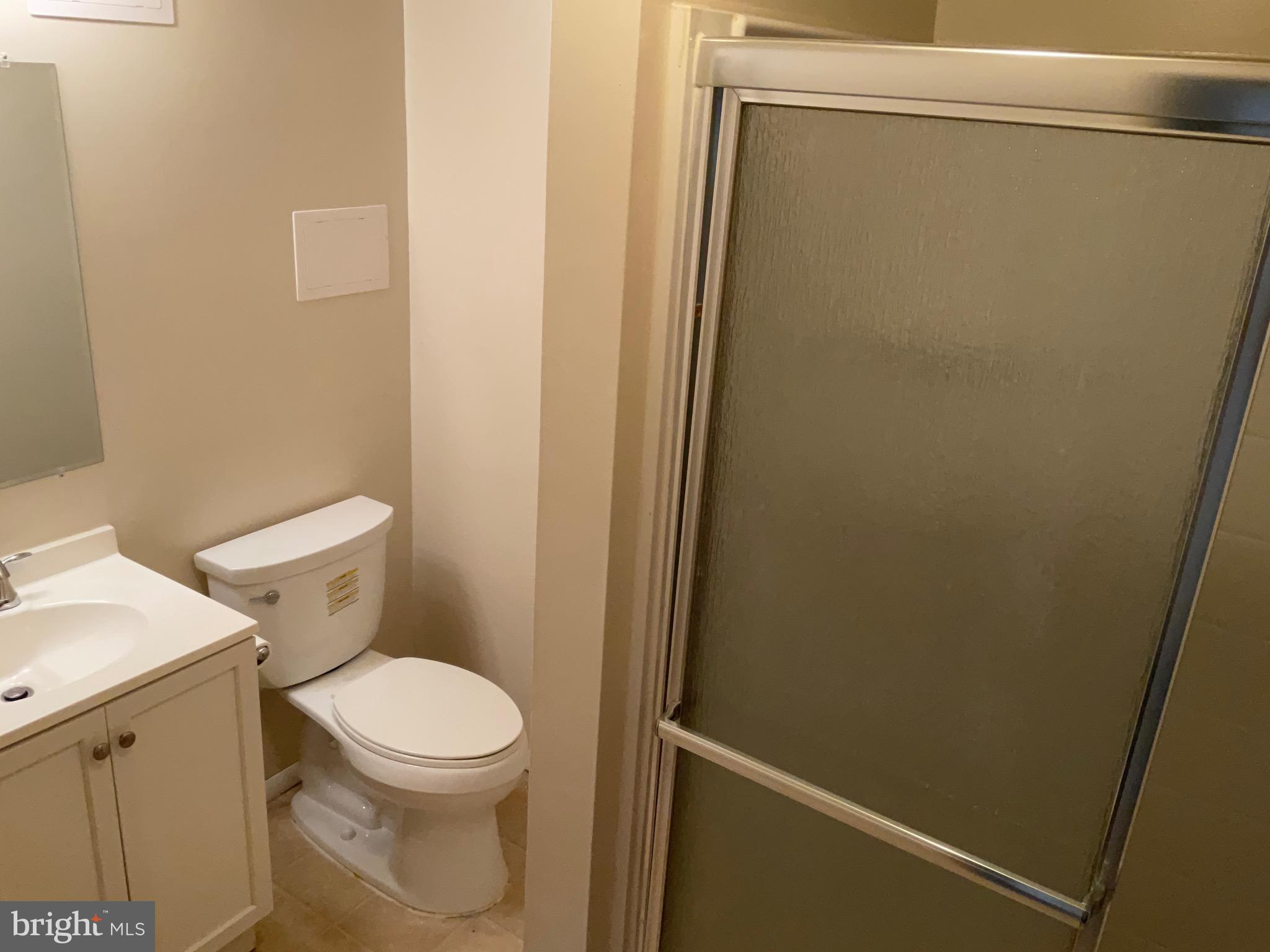 9218 Briarchip Street Laurel, MD 20708 - Photo 32 of 38 a white toilet sitting next to a shower