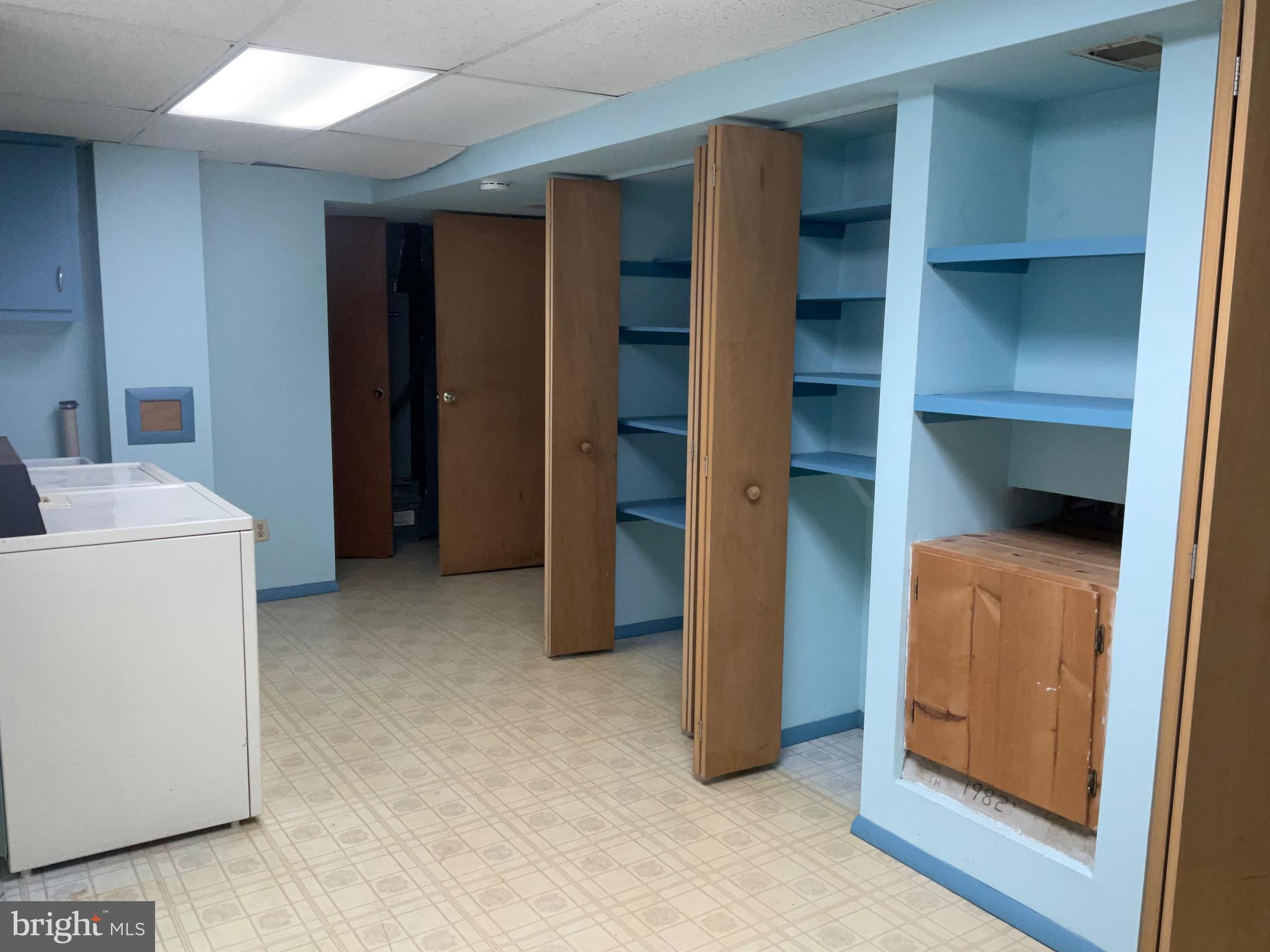 9218 Briarchip Street Laurel, MD 20708 - Photo 35 of 38 a view of an empty room with cabinet and utility room