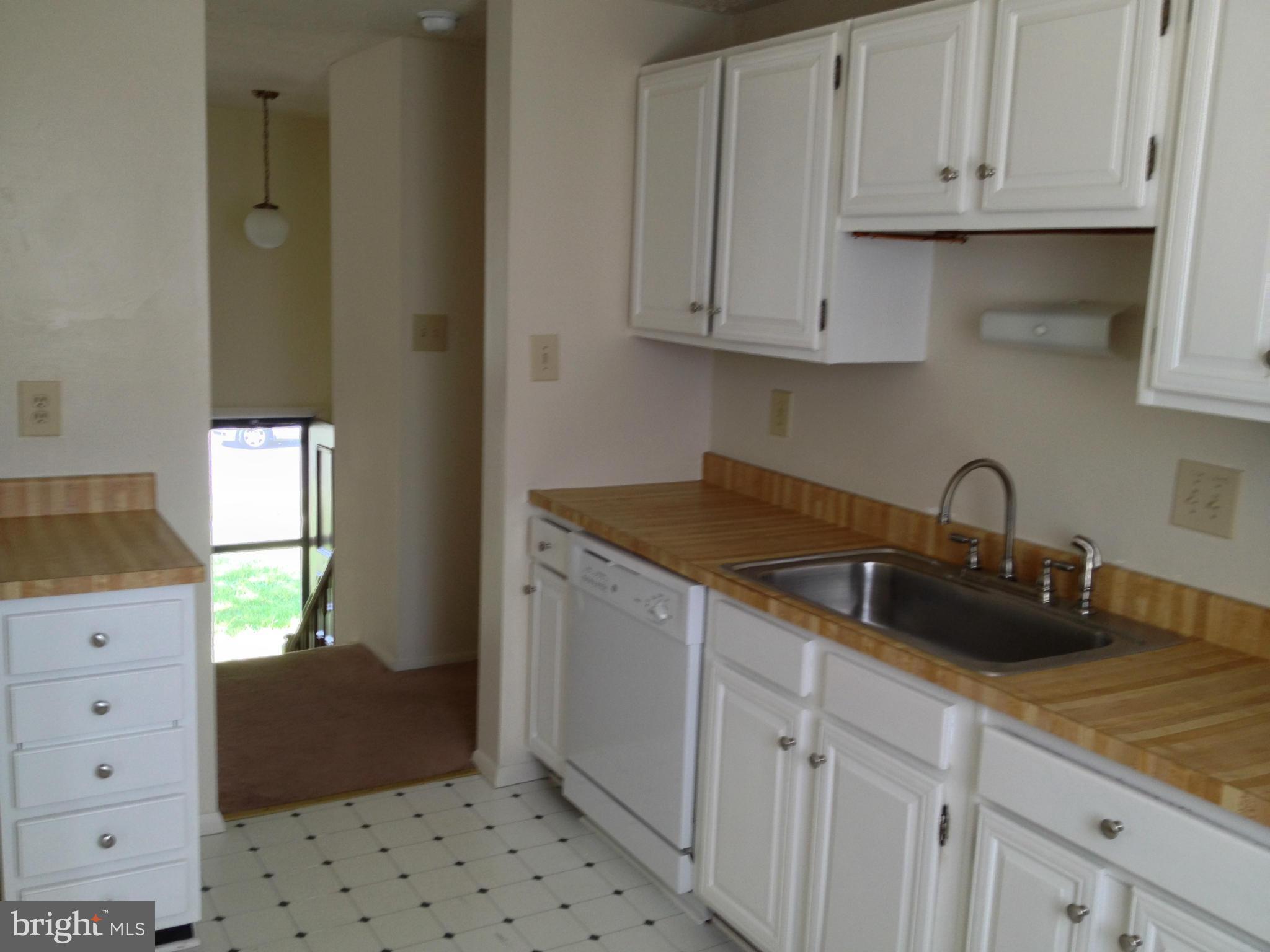 9218 Briarchip Street Laurel, MD 20708 - Photo 5 of 38 a kitchen with white cabinets and sink