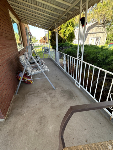 8320 West 3100th Street South Magna, UT 84044 - Photo 32 of 41 Covered porch with a storage shed