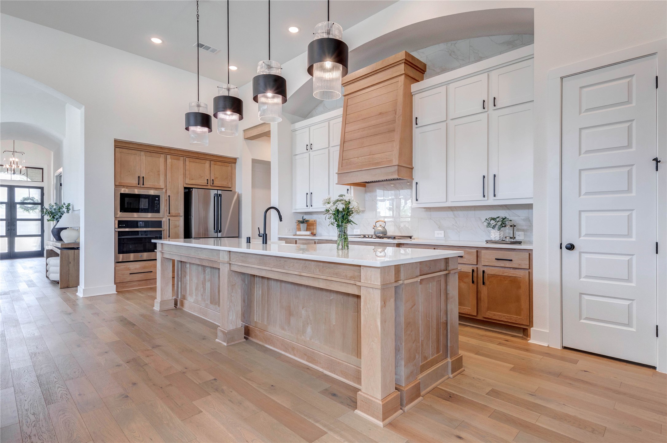 4510 Windmill Lndg Lane Fulshear, TX 77441 - Photo 2 of 48 a kitchen with white cabinets and stainless steel appliances