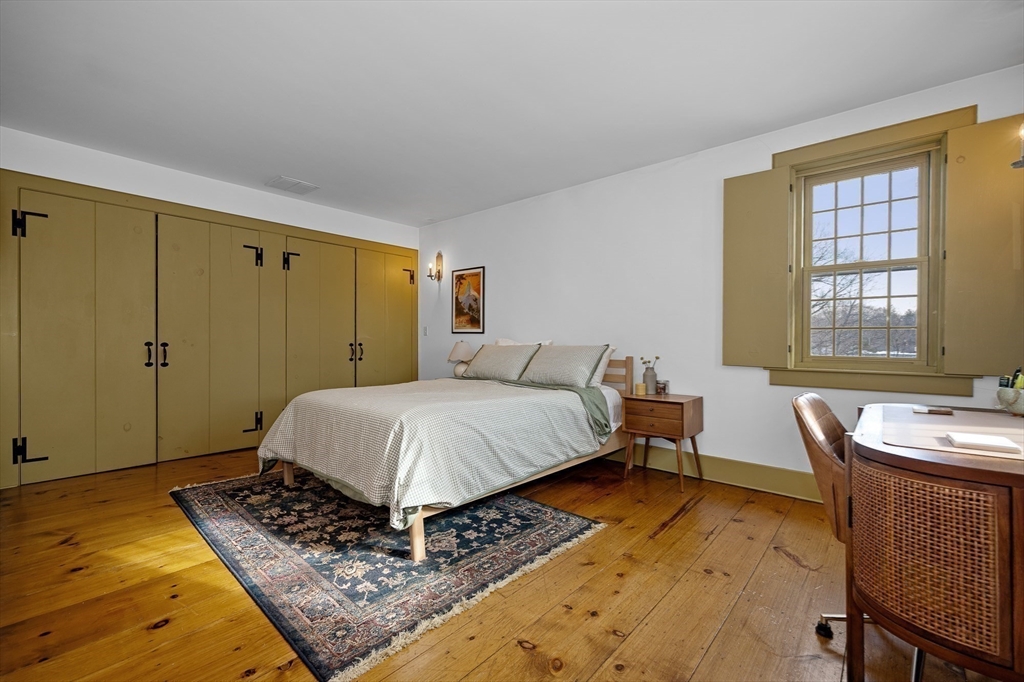 2 Marie Drive Blackstone, MA 01504 - Photo 28 of 42 a bedroom with a bed and wooden floor
