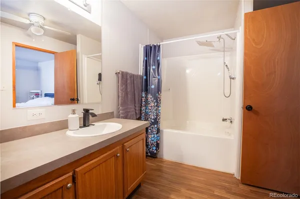 a bathroom with a double vanity sink a mirror a shower and a bathtub