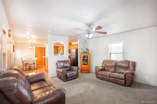 a living room with furniture a couch and dresser
