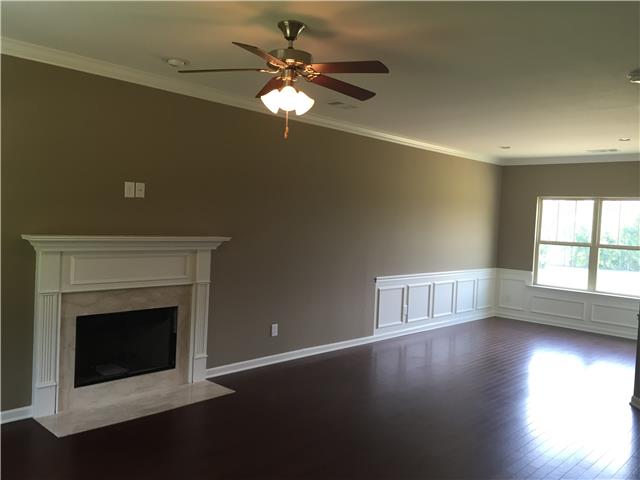 7373 Crow Cut Road Fairview, TN 37062 - Photo 2 of 7 a view of wooden floor fireplace and windows in an empty room
