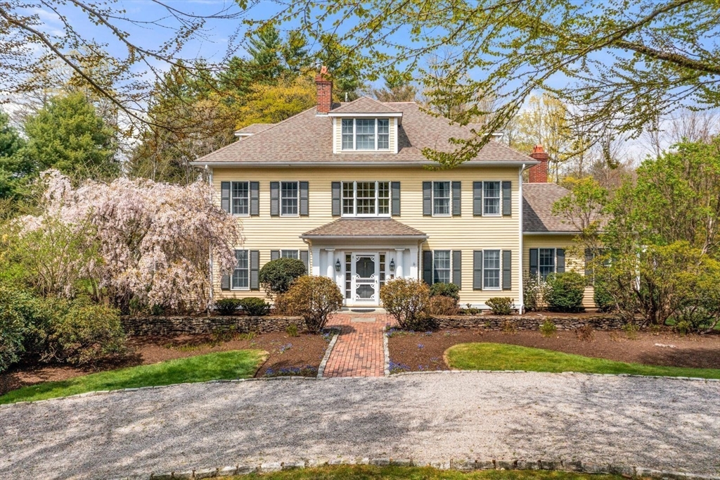 114 Farm Street Dover, MA 02030 - Photo 1 of 40 a front view of a house with a yard table and chairs