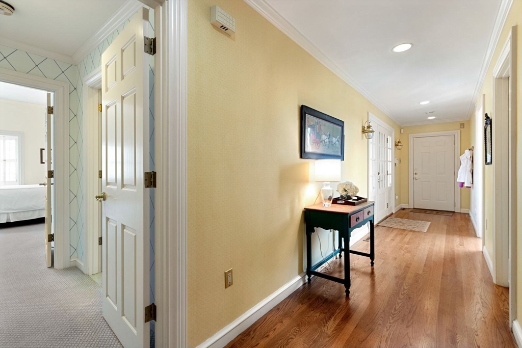 114 Farm Street Dover, MA 02030 - Photo 16 of 40 a hallway with wooden floor and furniture