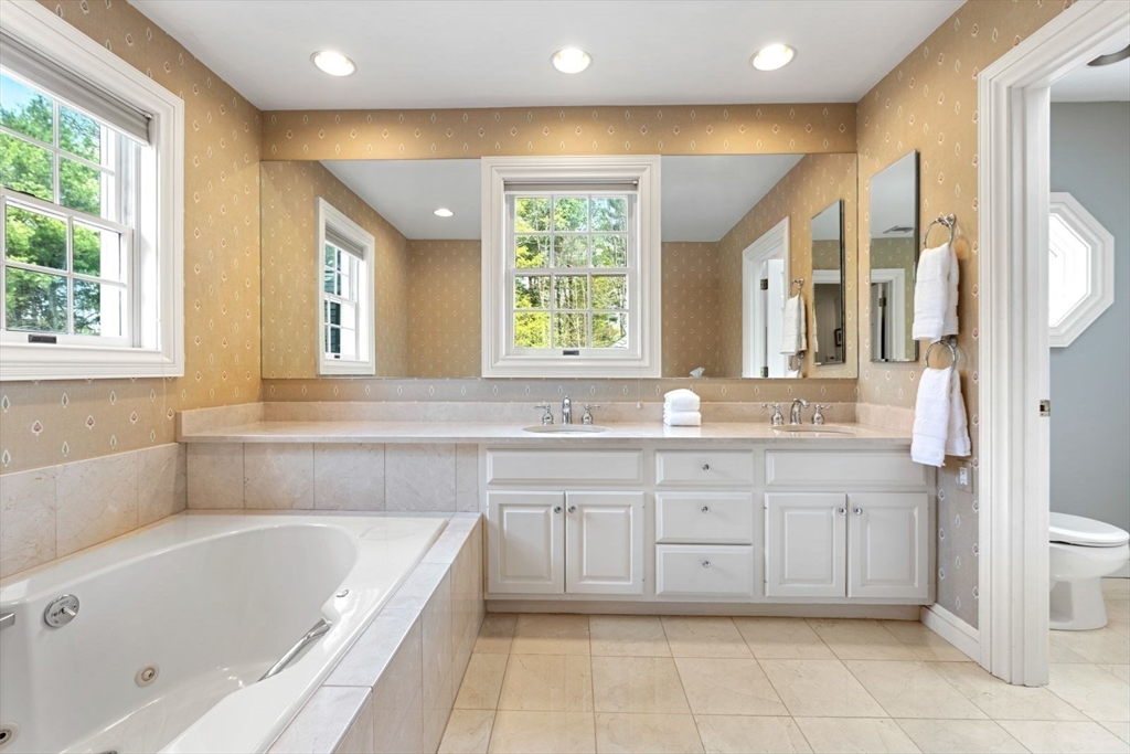 114 Farm Street Dover, MA 02030 - Photo 24 of 40 a bathroom with a tub sink and a window