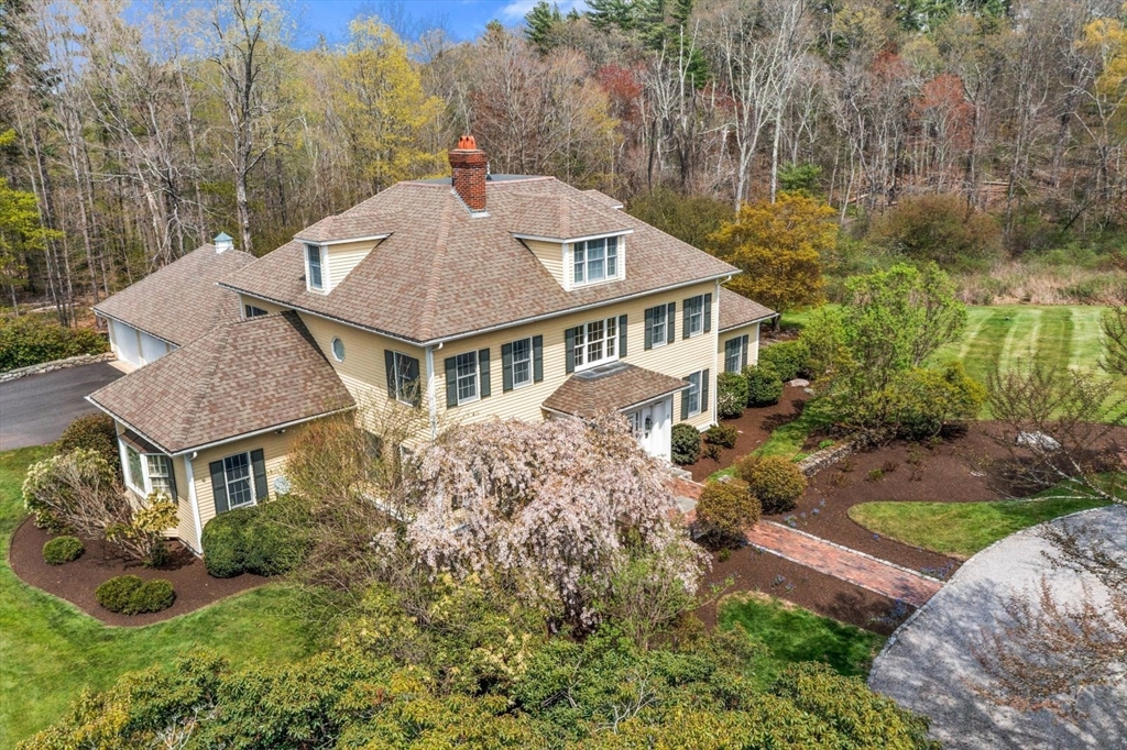 114 Farm Street Dover, MA 02030 - Photo 3 of 40 a aerial view of a house with yard and trees in the background