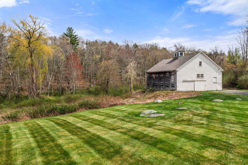 114 Farm Street Dover, MA 02030 - Photo 5 of 40 a view of a house with a yard and potted plants