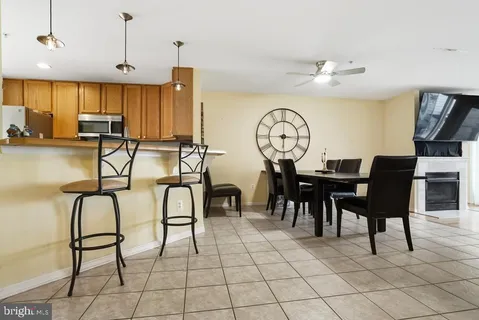 a view of a dining room with furniture and a chandelier