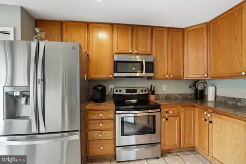 a kitchen with a refrigerator stove and microwave