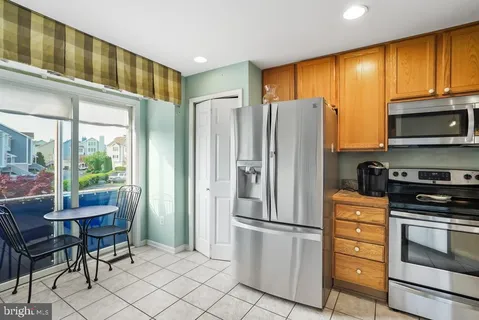 a kitchen with stainless steel appliances a refrigerator stove and microwave