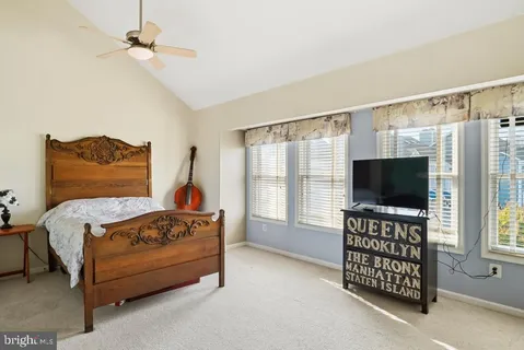 a bedroom with a bed and a flat tv screen