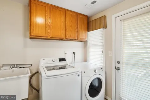 a view of washer and dryer with kitchen in the background