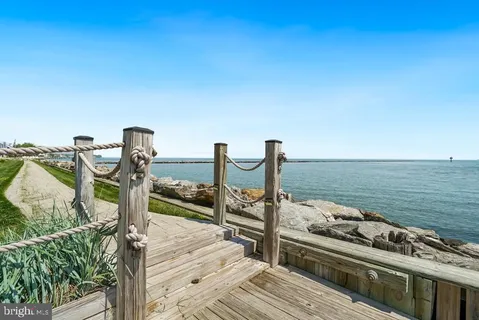 a view of a ocean with two chairs
