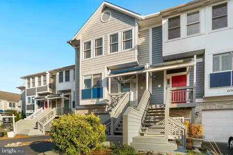 a front view of a residential apartment building with a yard