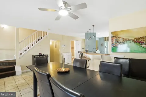 a living room with furniture and a view of kitchen