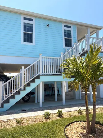 a view of a house with backyard porch and sitting area