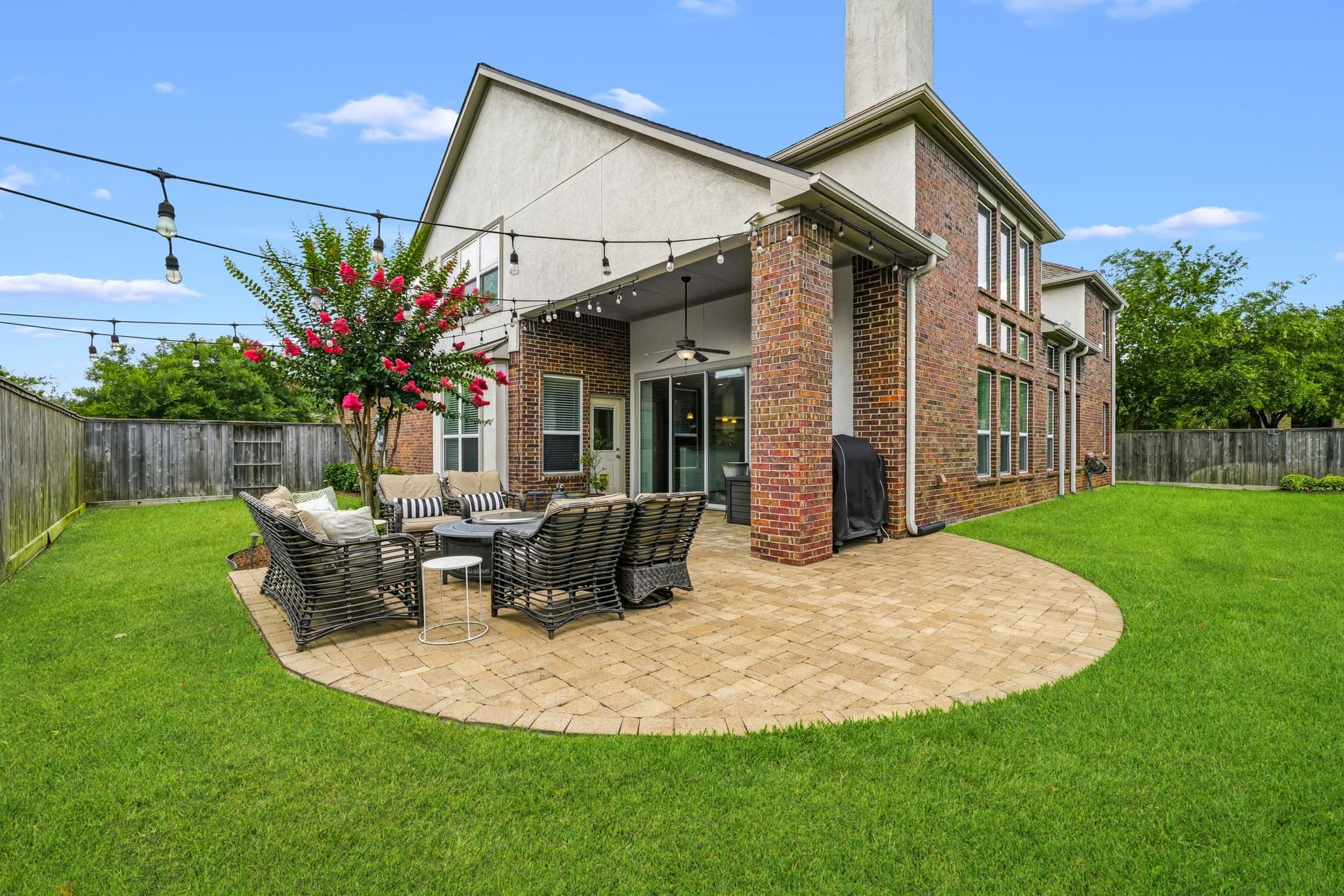 17610 Strackfield Lane Tomball, TX 77377 - Photo 49 of 50 Framed by elegant brick columns and enhanced by tall ceilings, this covered patio offers a comfortable and sophisticated setting for morning coffee, evening gatherings, and everything in between.