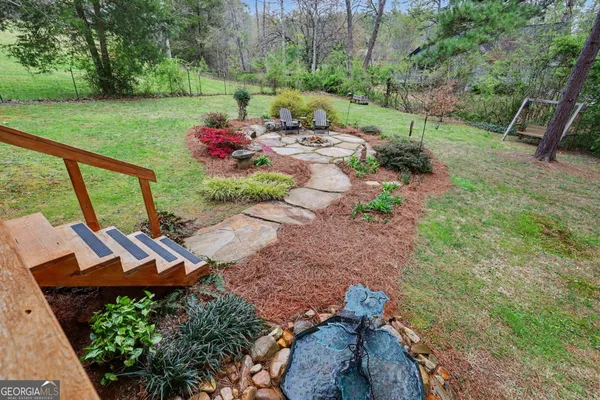 a view of a garden with an outdoor seating