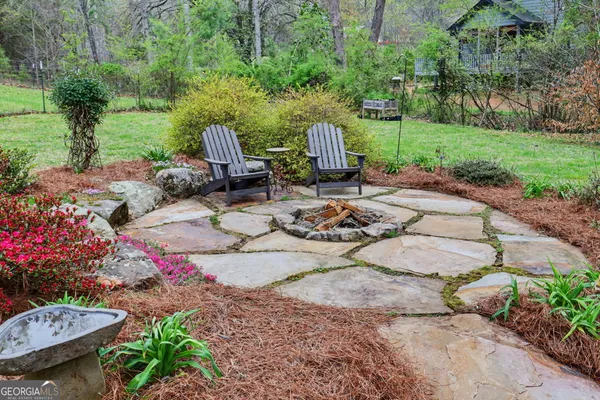 a view of a backyard with sitting area and garden