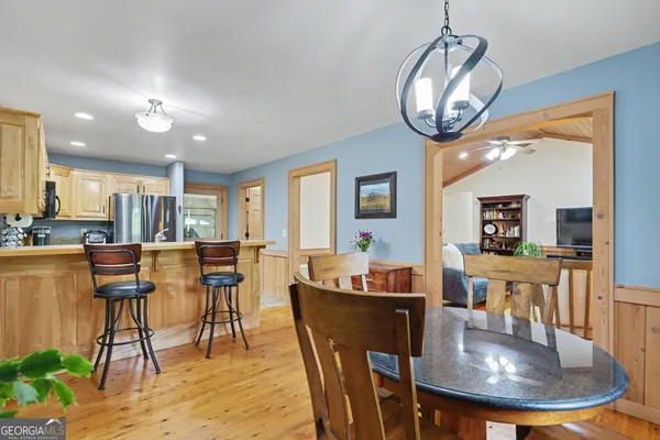 a dining room with furniture a wooden floor and chandelier